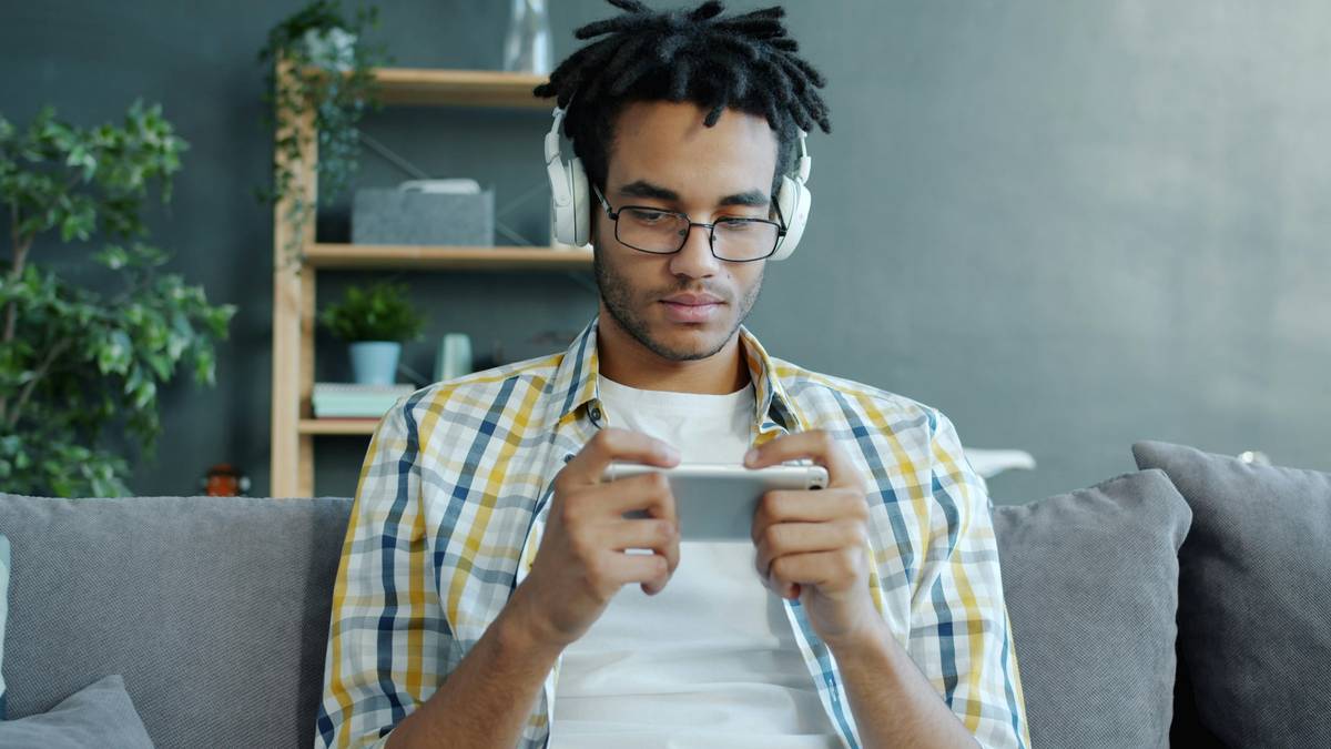 Player focused on smartphone during tournament competitive mobile gaming event